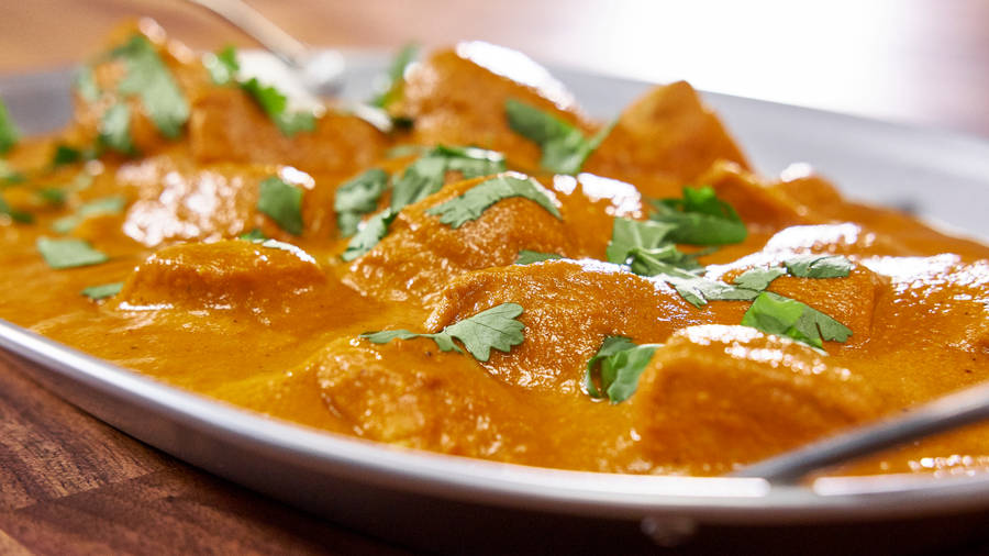 Orange Colored Butter Chicken Dish Wallpaper