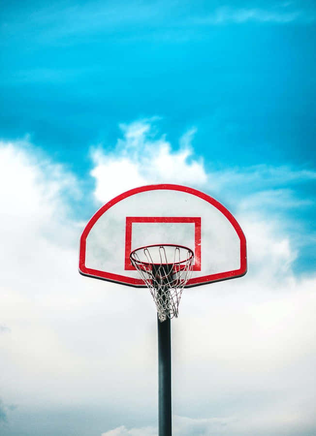 Outdoor Basketball Hoop Against Blue Sky Wallpaper