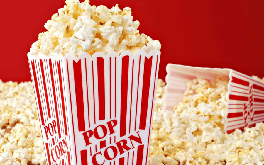 Overflowing Popcorn Box Red Background Wallpaper