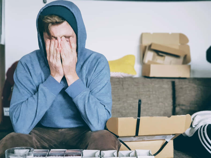 Overwhelmed Man In A Hoodie Wallpaper