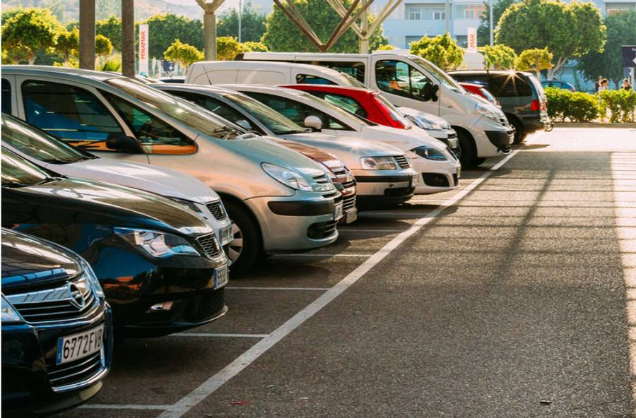 Parking Lot With Neatly Parked Cars Wallpaper