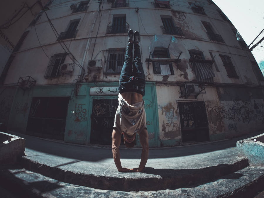 Parkour Performer Under Building Wallpaper