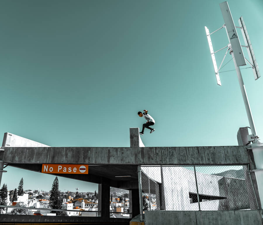 Parkour Person Above Concrete Building Wallpaper