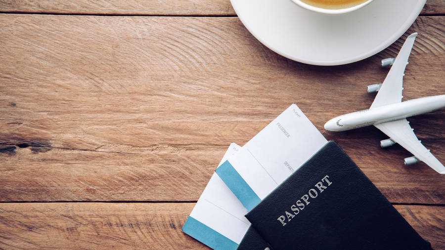 Passport And Toy Airplane On Table Wallpaper