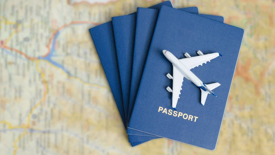 Passport With Toy Airplane On Top Wallpaper