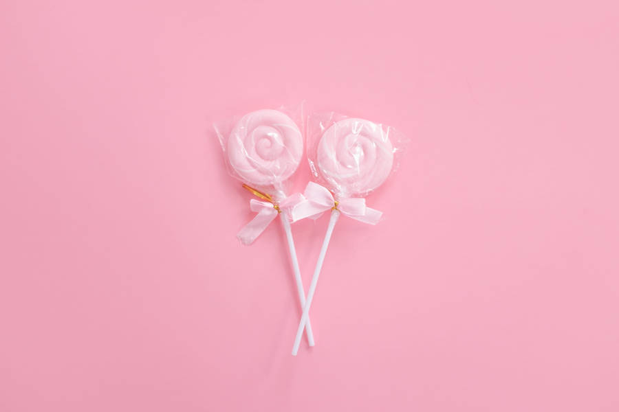 Pastel Colored Lollipops On Desktop Wallpaper