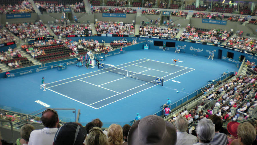 Patrick Rafter Exhibiting Skill And Precision In An Arena Tennis Match Wallpaper