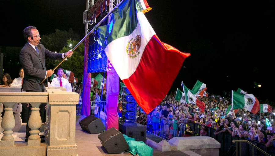 Patriotic Man Holding The Mexico Flag Wallpaper