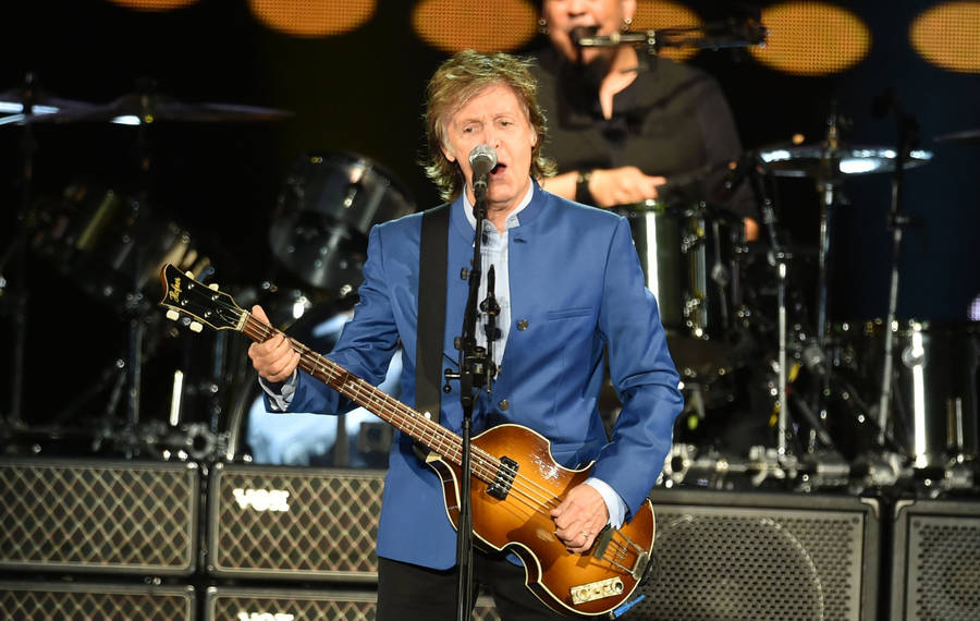 Paul Mccartney Playing Small Guitar Wallpaper