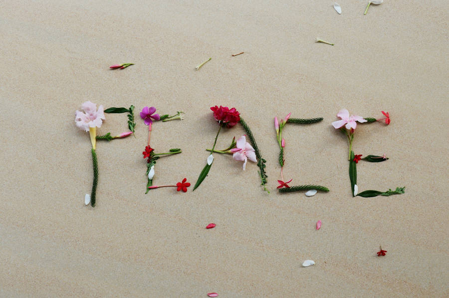 Peace Symbol Flowers On Sand Wallpaper