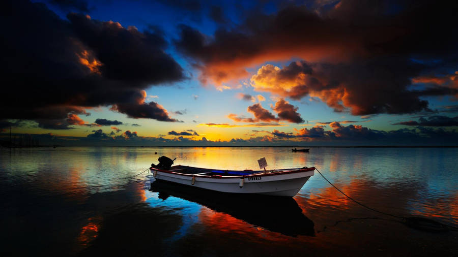 Peaceful Darkened Sky Over A Boat Wallpaper