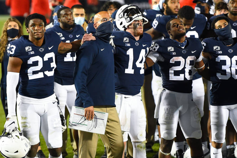 Penn State Football Players Standing On The Field Wallpaper