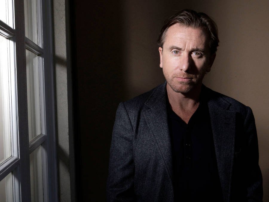 Pensive Tim Roth In Black Attire Wallpaper