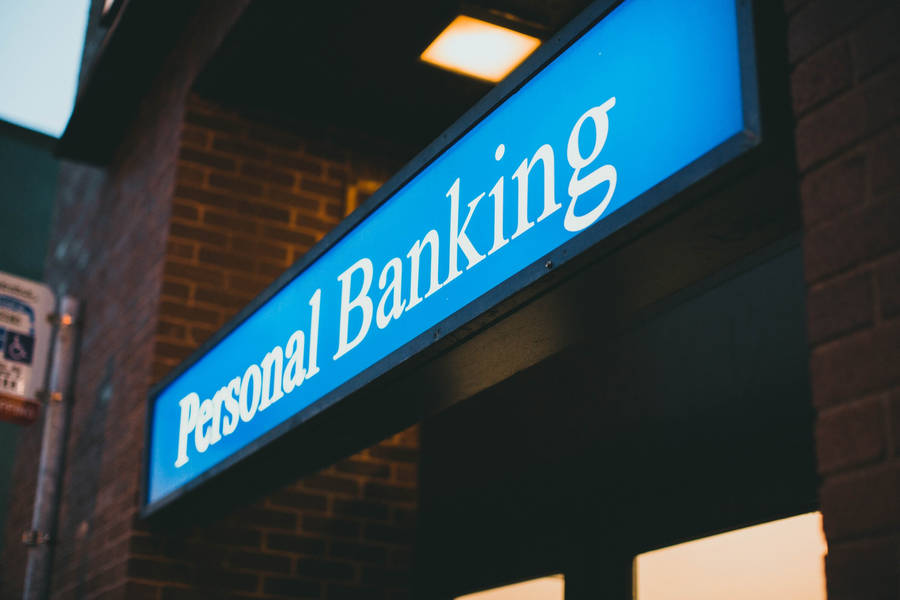 Personal Banking Signage At A Bank Branch Wallpaper