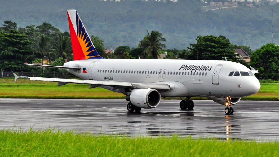 Philippine Airlines Airplane On Wet Runway Wallpaper