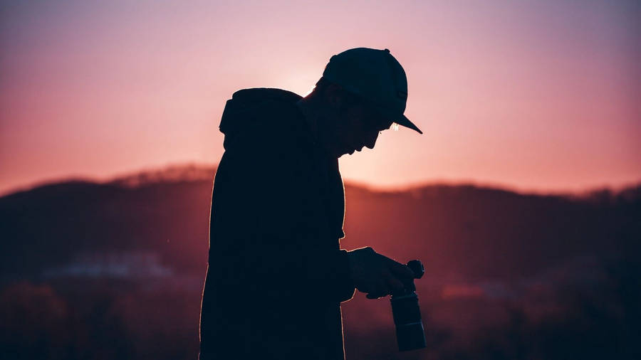 Photographer Under Pink Sunset Wallpaper