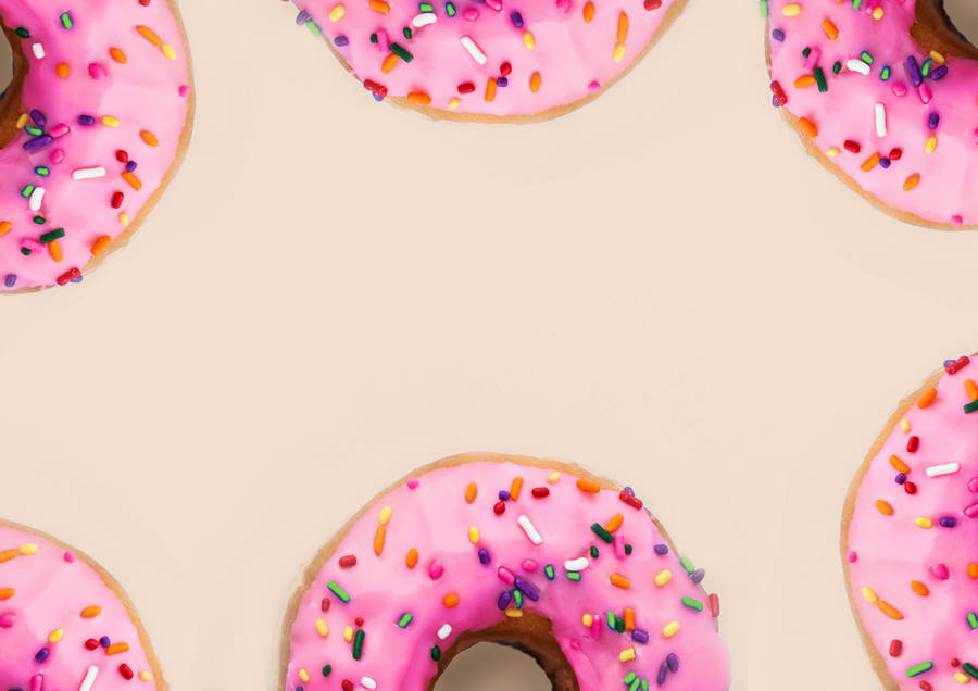 Pink Doughnuts Background Wallpaper