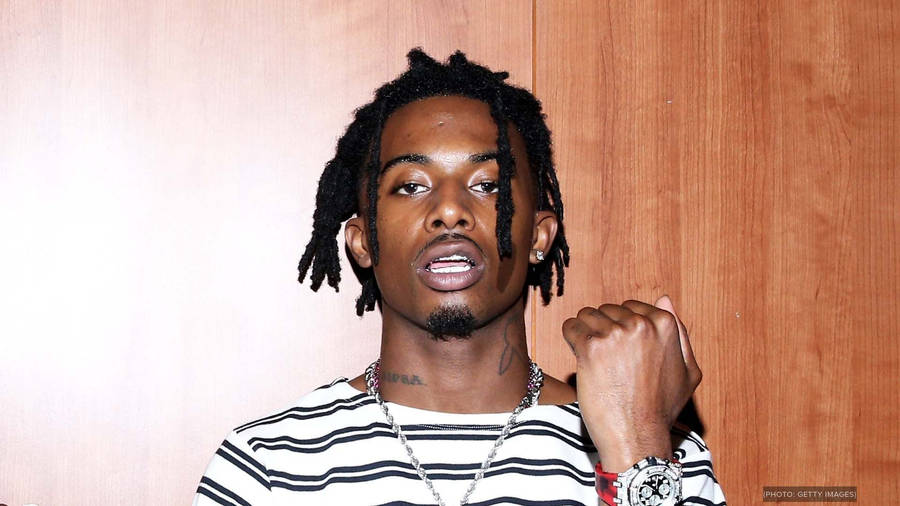 Playboi Carti Holding Fist Up Wallpaper