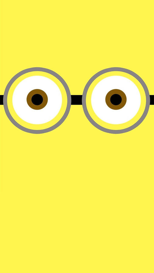 Playful Minion Eyes On A Cute Yellow Background Wallpaper