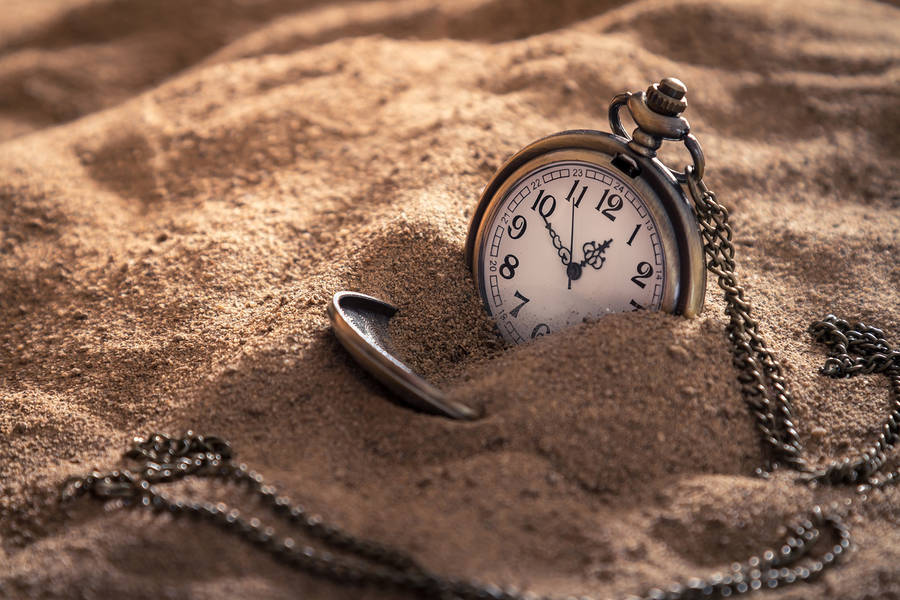 Pocket Watch On Sand Wallpaper