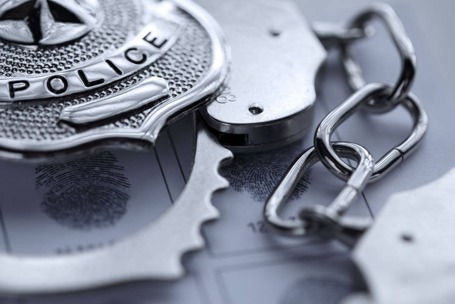 Police Officer Badge And Steel Handcuff Wallpaper