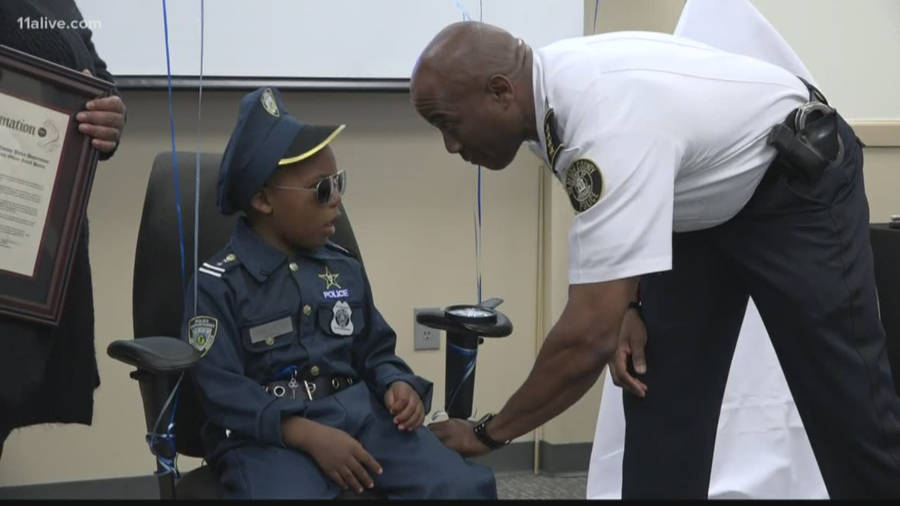 Police Officer Honors Boy Wallpaper