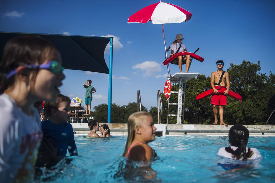 Pool Lifeguard Watching Over Kiddie Pool Wallpaper