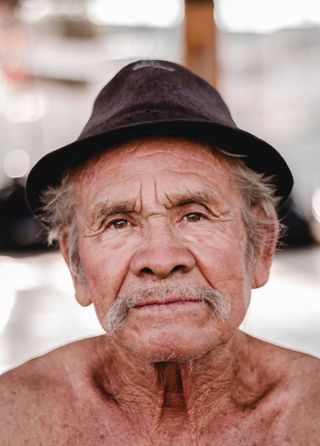 Portrait Of An Elderly Man Adorned In Black Fedora Hat Wallpaper