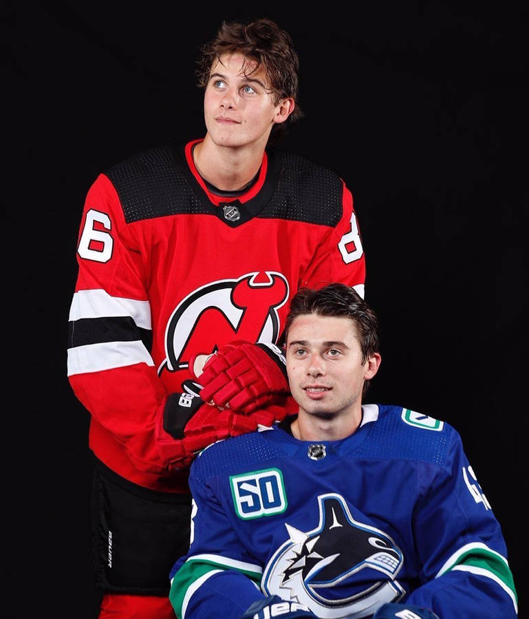 Portrait Of Quinn Hughes Posing With Brother Jack Hughes From New Jersey Devils Wallpaper