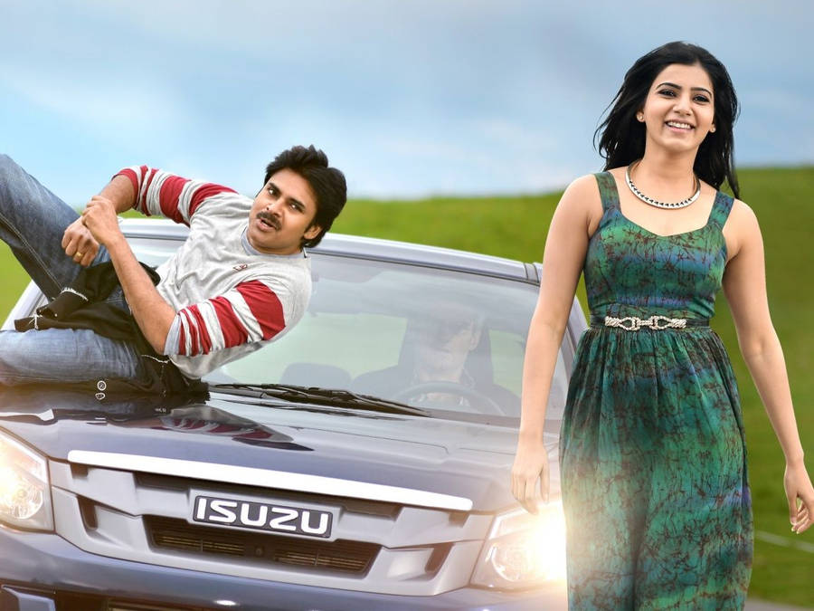 Power Star Pawan Kalyan And Samantha Ruth Prabhu In Casual Attire Near A Vintage Car Wallpaper