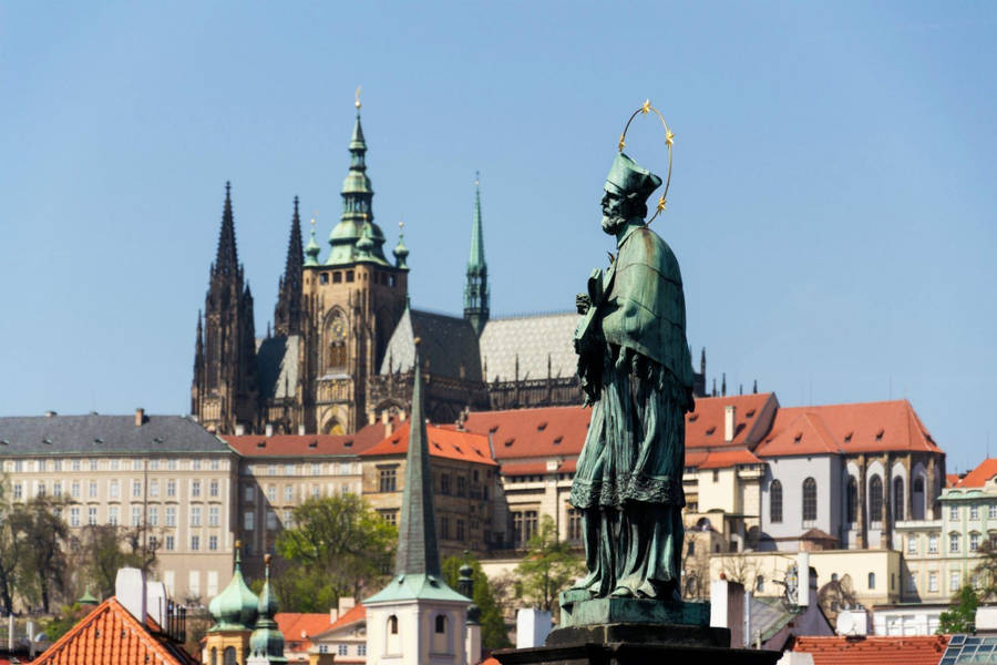 Prague Castle And Historic Statue At Sunset Wallpaper