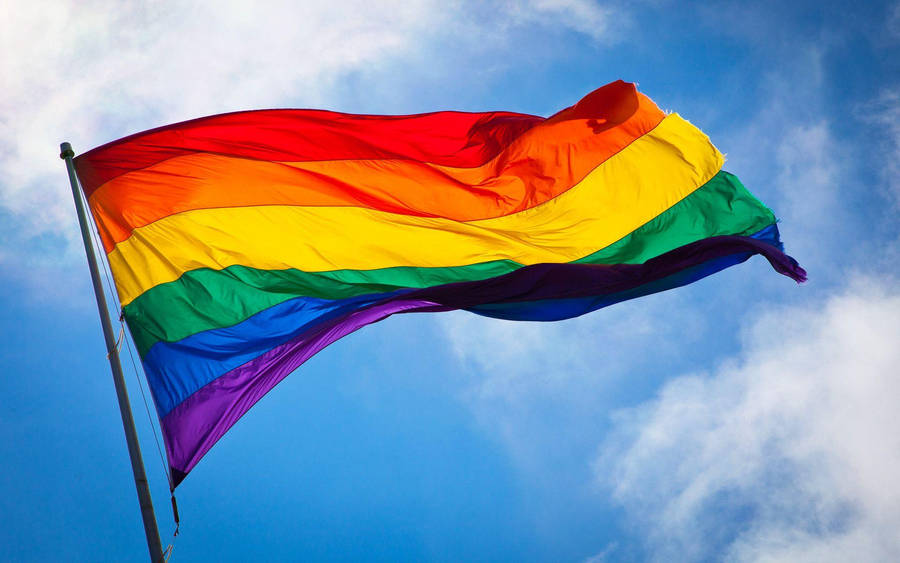 Pride Flag Against Cloudy Sky Wallpaper