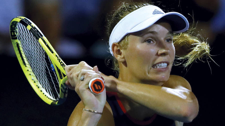 Pro Tennis Player Caroline Wozniacki In Action Wallpaper