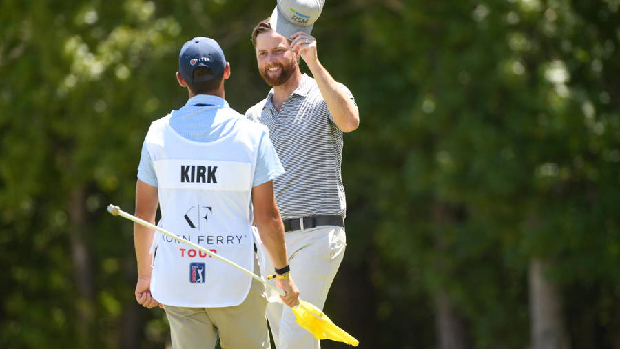 Professional Golfer Chris Kirk In Conversation With His Caddie During A Golf Tournament Wallpaper