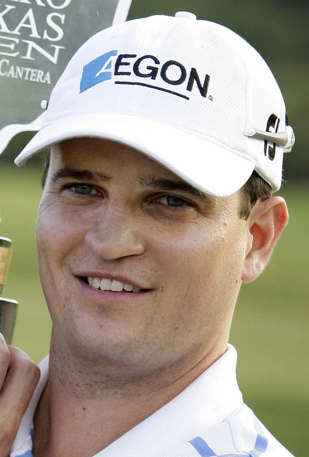 Professional Golfer Zach Johnson Showcasing His Elegant Poise While Wearing A White Cap Wallpaper