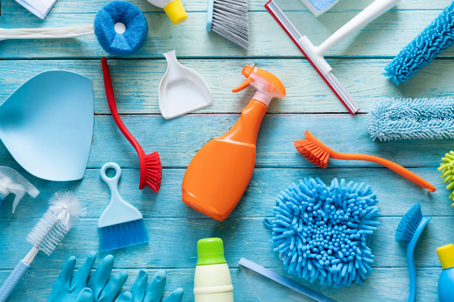 Professional Housekeeper In Action With Cleaning Equipment Wallpaper