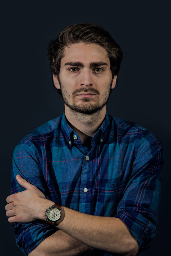 Professional Man In Blue Checkered Shirt Headshot Wallpaper