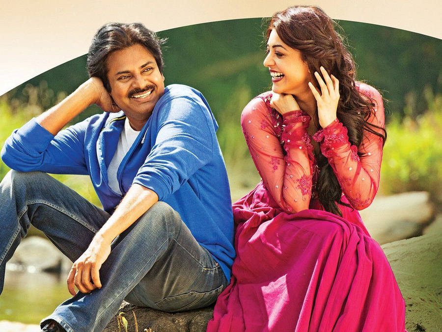 Pspk And Kajal Aggarwal Seated Together Wallpaper