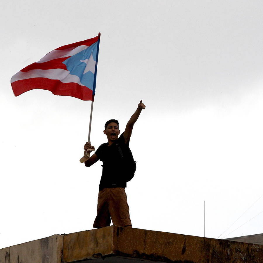 Puerto Rican Flag Hold By Teen Wallpaper