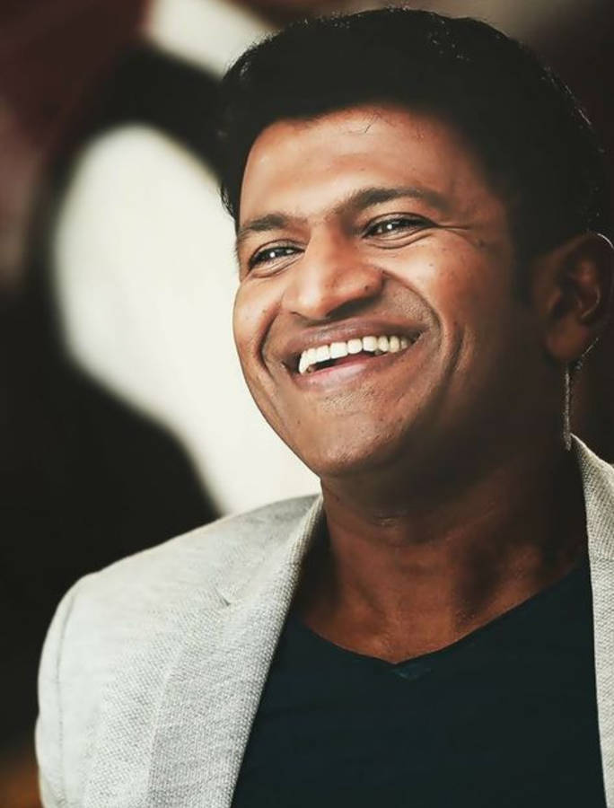 Puneeth Rajkumar Happy Portrait Wallpaper