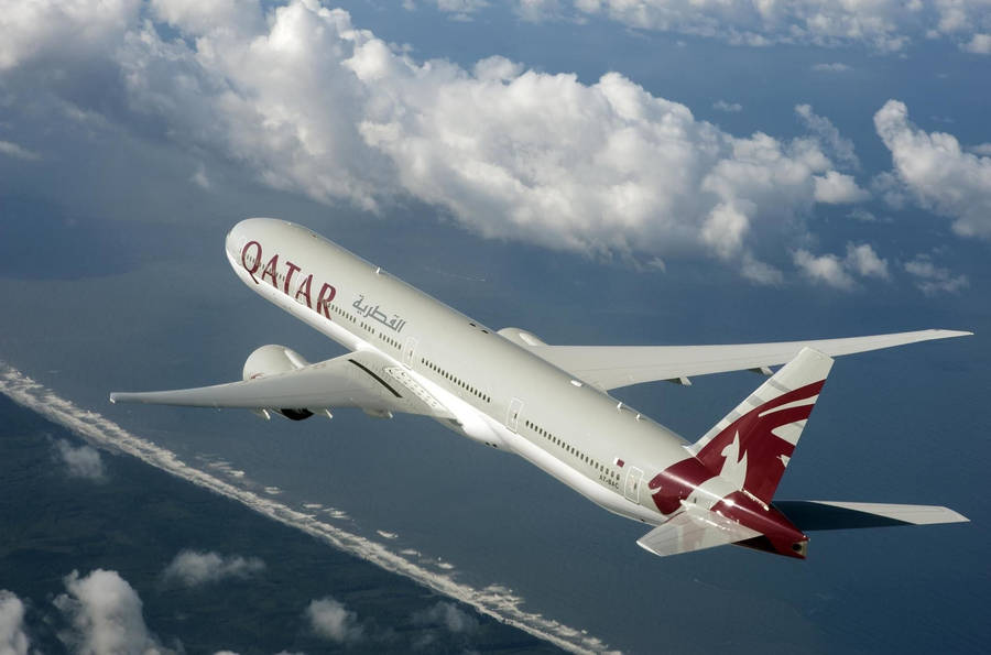 Qatar Airways Flying Into The Feathery Clouds Wallpaper