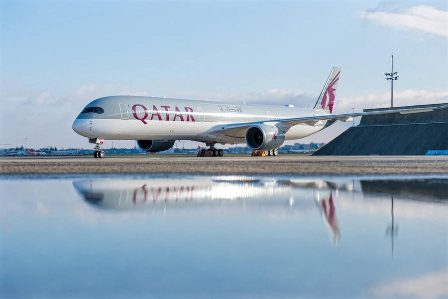 Qatar Airways Plane By A Pool Of Calm Water Wallpaper