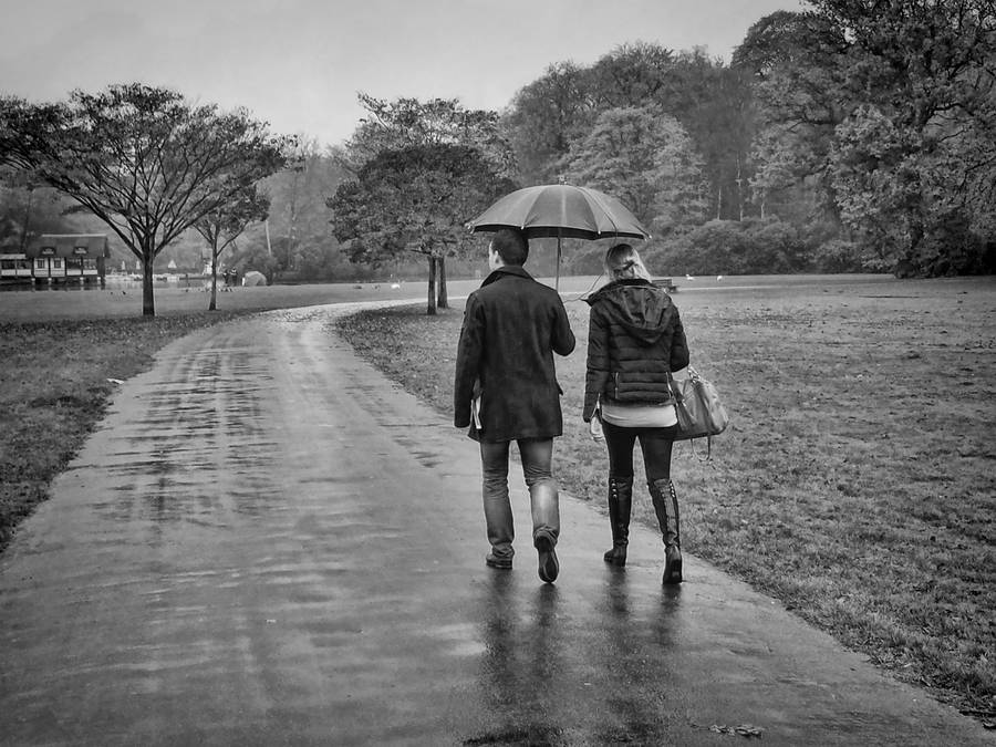 Rain Couple On Paved Road Wallpaper