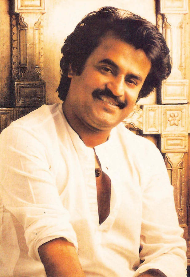 Rajinikanth Against Golden Wall Wallpaper