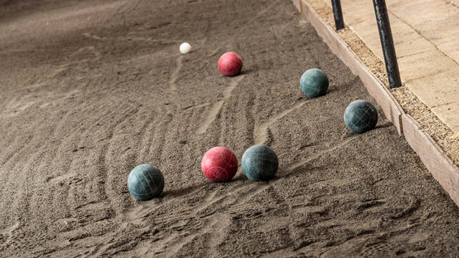 Ready For The Toss - Bocce Ball On Sand Court Wallpaper