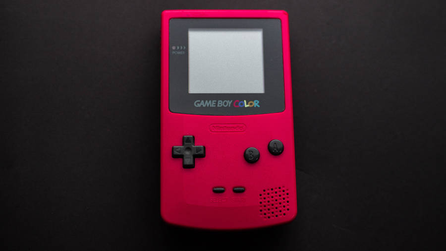 Red Game Boy Color On Black Surface Wallpaper