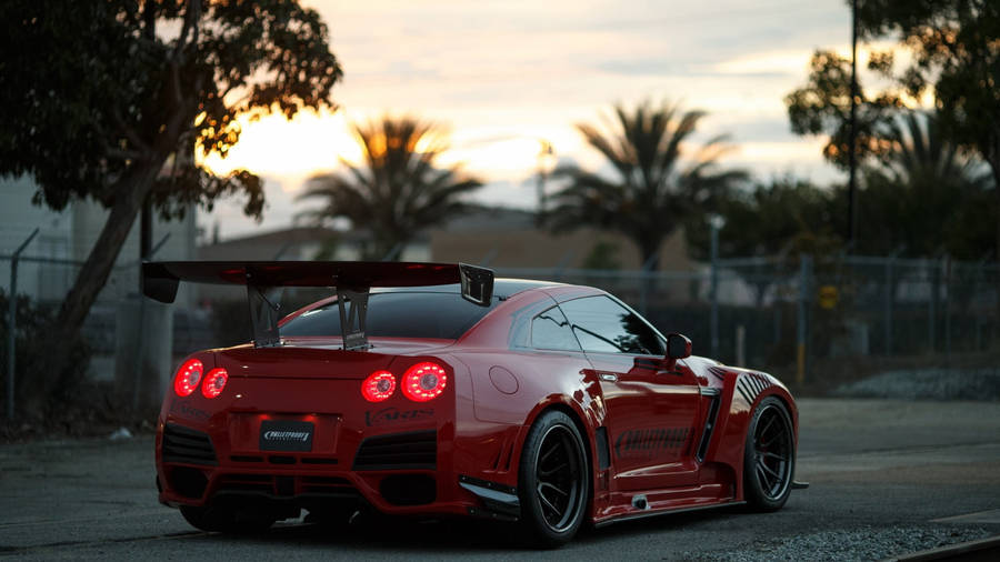 Red Gtr Racing Car In Road Wallpaper