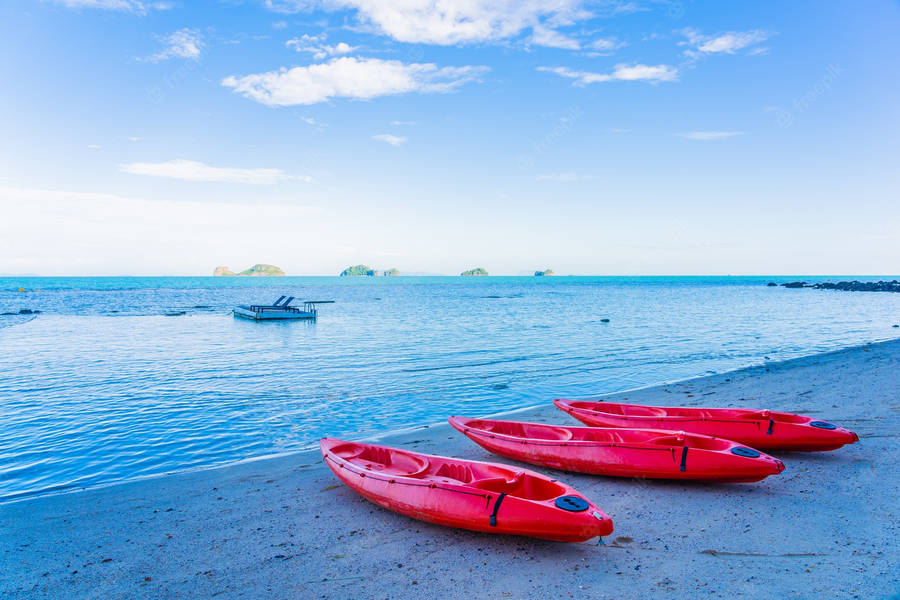 Red Kayaks By The Beach Wallpaper