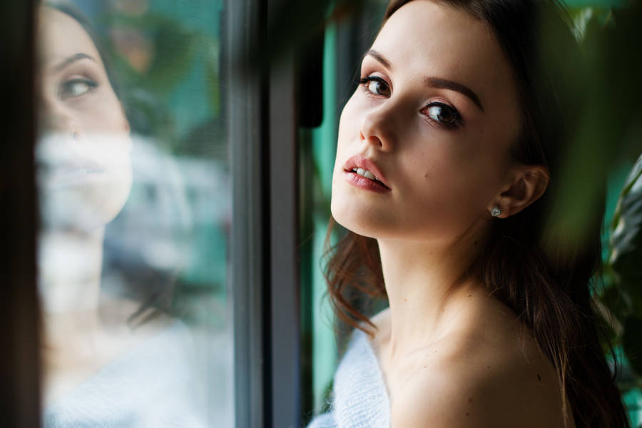 Reflective Mindset - Mature Woman Gazing Through The Window Wallpaper