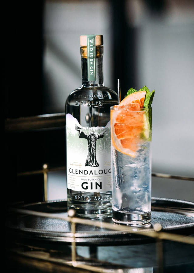 Refreshing Glendalough Wild Gin Tonic Cocktail Against A Rustic Backdrop Wallpaper